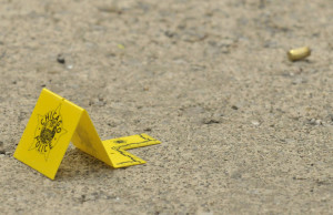 Chicago Police marker to a gun casing (top right)  work the crime scene Tuesday afternoon in the 7000 block of south Rockwell reports of three people shot.  | Scott Stewart~Sun-TimesChicago Police work the crime scene Tuesday afternoon in the 7000 block of south Rockwell reports of three people shot.  | Scott Stewart~Sun-Times